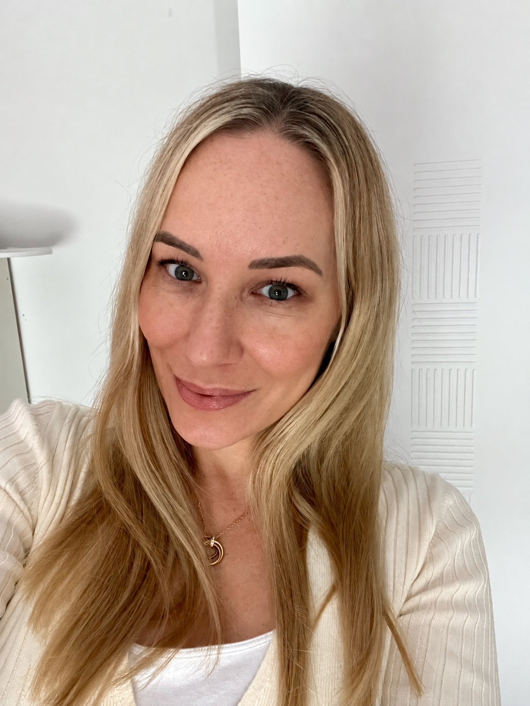 Close-up portrait of Sandra in a white top with her hair worn down